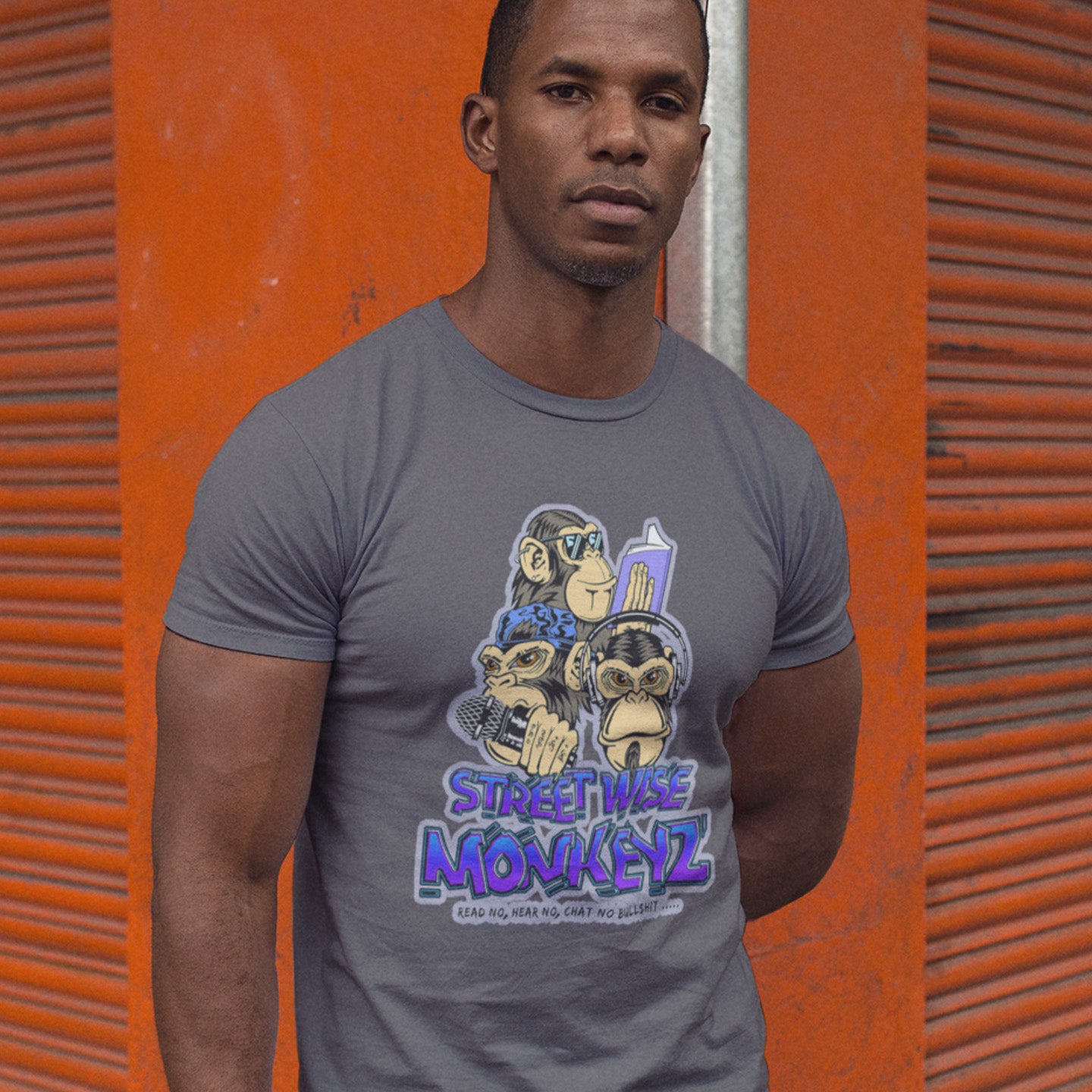 Man standing in the street wearing anthracite 'street wise monkeyz' t-shirt. A street art graffiti t-shirt design depicting a modern slant on the three wise monkeys. It's time to be street wise. Hear and see everything and have your say. The time for ignorance is over. Made from 100% organic ring-spun cotton, this street art t-shirt is unisex, high-quality, super comfy, and best of all, eco-friendly.