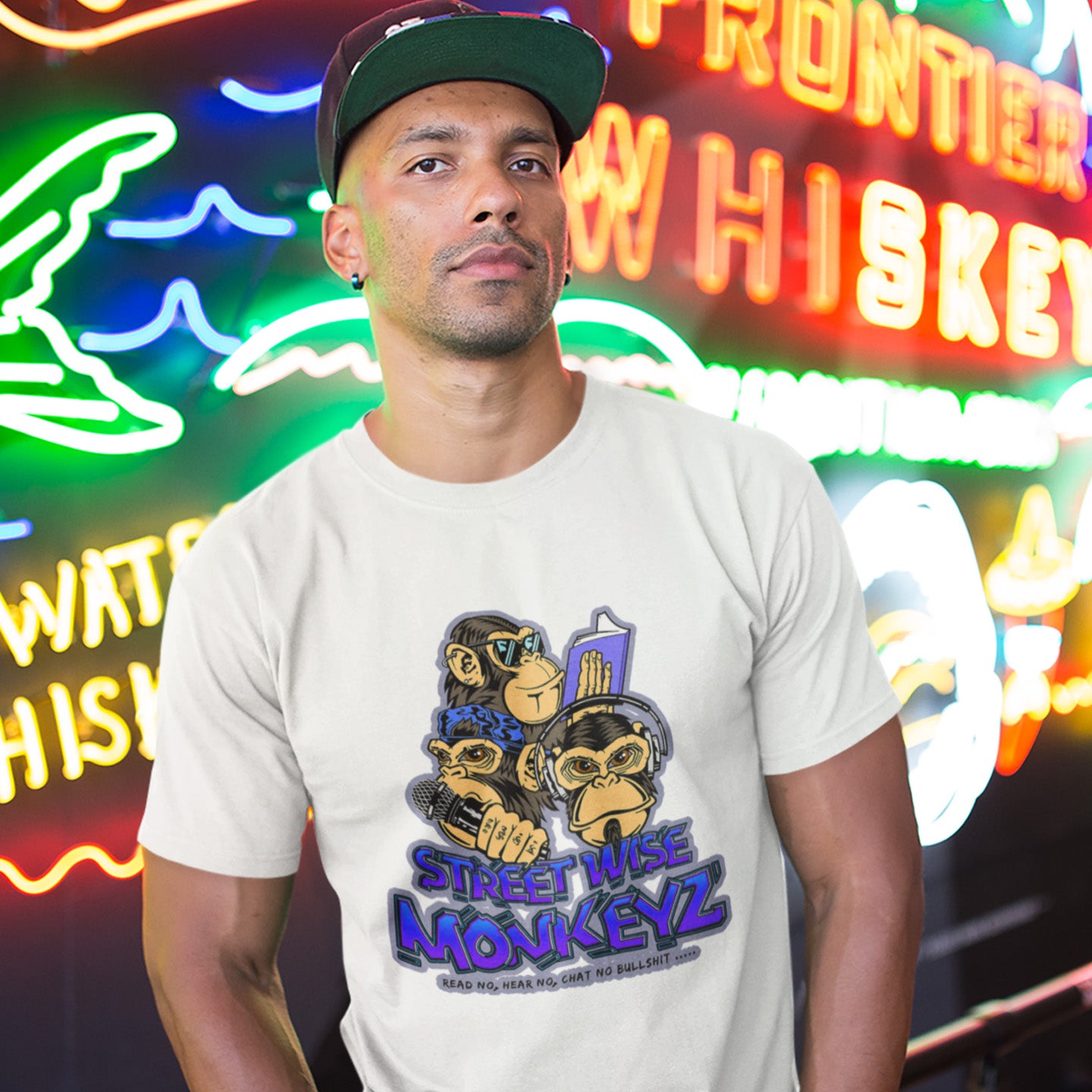 Man wearing white t-shirt with street wise monkeyz logo. A street art graffiti t-shirt design depicting a modern slant on the three wise monkeys. It's time to be street wise. Hear and see everything and have your say. The time for ignorance is over. Made from 100% organic ring-spun cotton, this street art t-shirt is unisex, high-quality, super comfy, and best of all, eco-friendly.