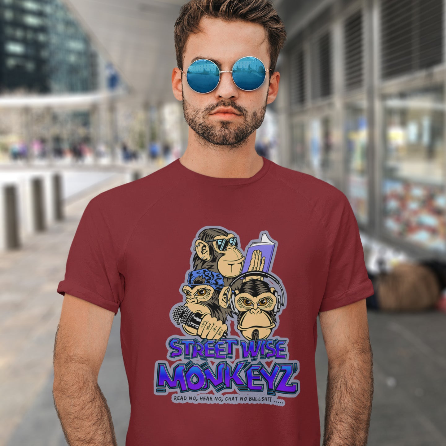 Man standing in the street wearing a burgundy 'street wise monkeyz' t-shit. A urban graffiti t shirt design depicting a modern slant on the three wise monkeys. It's time to be street wise. Hear and see everything and have your say. The time for ignorance is over. Made from 100% organic ring-spun cotton, this urban art t shirt is unisex, high-quality, super comfy, and best of all, eco-friendly.