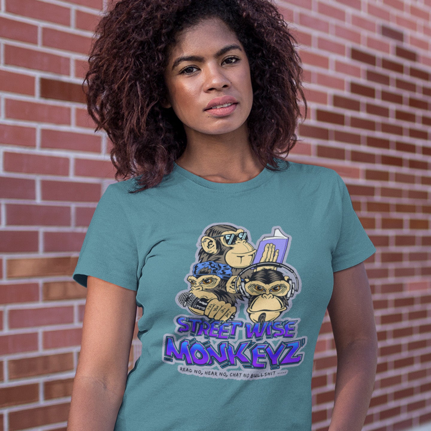 woman wearing a stargazer t-shirt with 'street wise monkeyz' logo, standing in the street. A urban graffiti t shirt design depicting a modern slant on the three wise monkeys. It's time to be street wise. Hear and see everything and have your say. The time for ignorance is over. Made from 100% organic ring-spun cotton, this urban art t shirt is unisex, high-quality, super comfy, and best of all, eco-friendly.