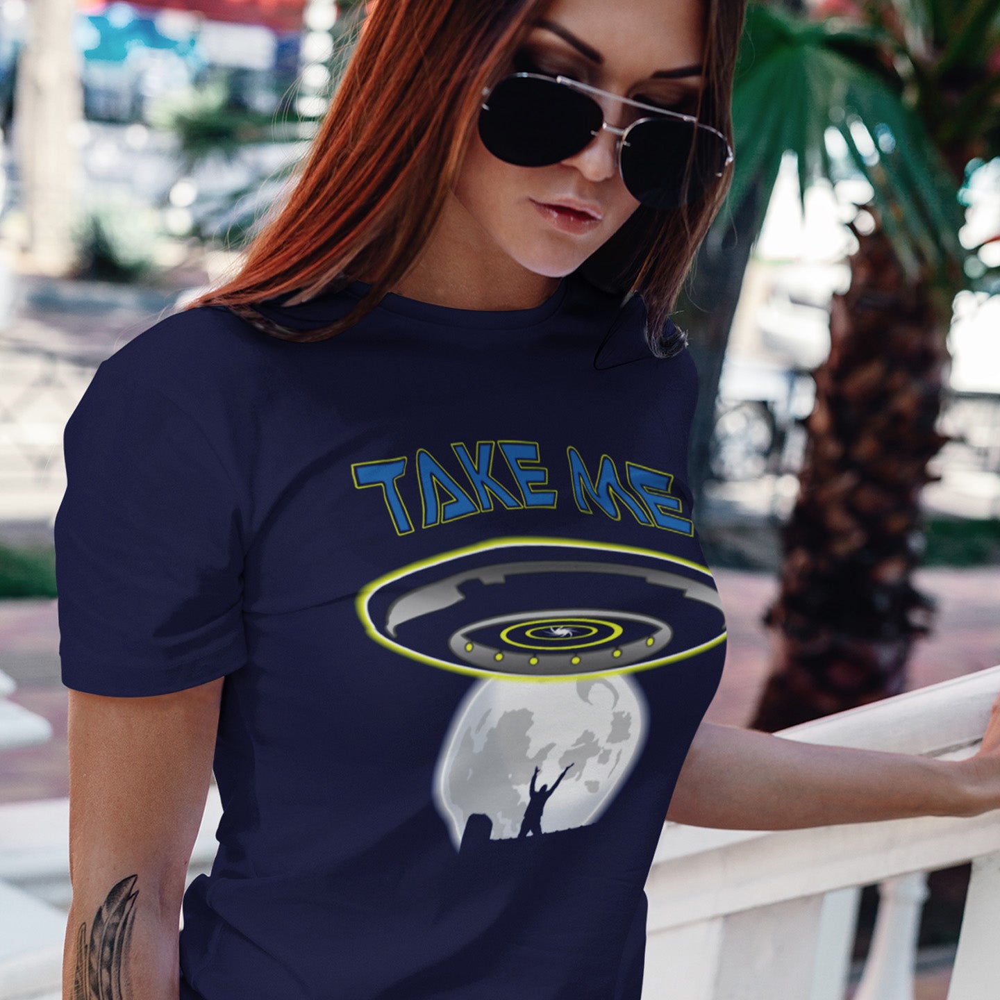 Woman wearing a French navy blue t-shirt with a UFO design and 'TAKE ME' text. This alien abduction t shirt is a must for everyone who feels they have you had enough of this planet or, more to the point, the human race. Do you sometimes think you would be better off being abducted ? Made from 100% organic ring-spun cotton, this cool sci fi t shirt is unisex, high-quality, super comfy, and best of all, eco-friendly.
