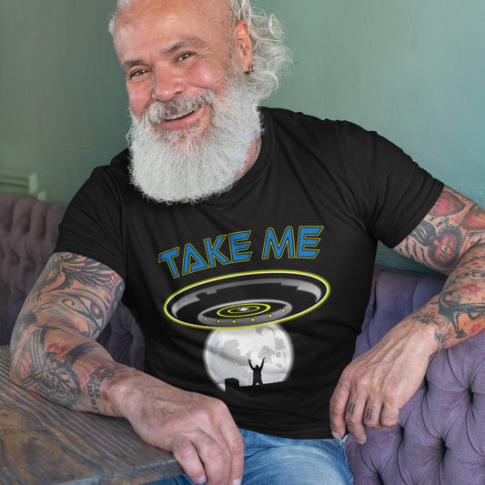 Man wearing a black t-shirt with 'TAKE ME' graphic design, sitting on a couch. This alien abduction t shirt is a must for everyone who feels they have you had enough of this planet or, more to the point, the human race. Do you sometimes think you would be better off being abducted ? Made from 100% organic ring-spun cotton, this cool sci fi t shirt is unisex, high-quality, super comfy, and best of all, eco-friendly.