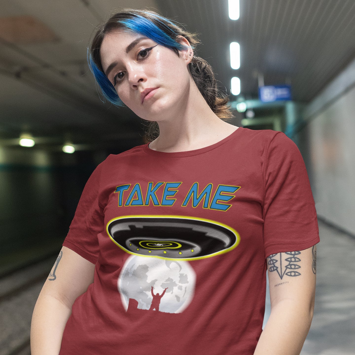 Person wearing a burgundy t-shirt with 'TAKE ME' graphic design in an indoor setting. This funny alien abduction t-shirt is a must for everyone who feels they have you had enough of this planet or, more to the point, the human race. Do you sometimes think you would be better off being abducted ? Made from 100% organic ring-spun cotton, this funny sci fi t-shirt is unisex, high-quality, super comfy, and best of all, eco-friendly.