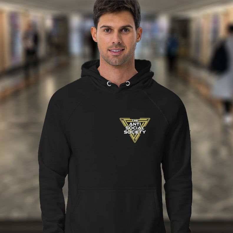 Man wearing a black hoodie with a anti social society logo in an indoor setting. This anti-social clothing design gives you an oxymoron to ponder, the more and more you don't want to be a member, the more you become one. A satirical counterculture dig at modern society. Comfortable and practical. It's extra soft and has a convenient front pouch pocket. Made from organic cotton and recycled polyester, this social awareness hoodie is a great eco-friendly choice.