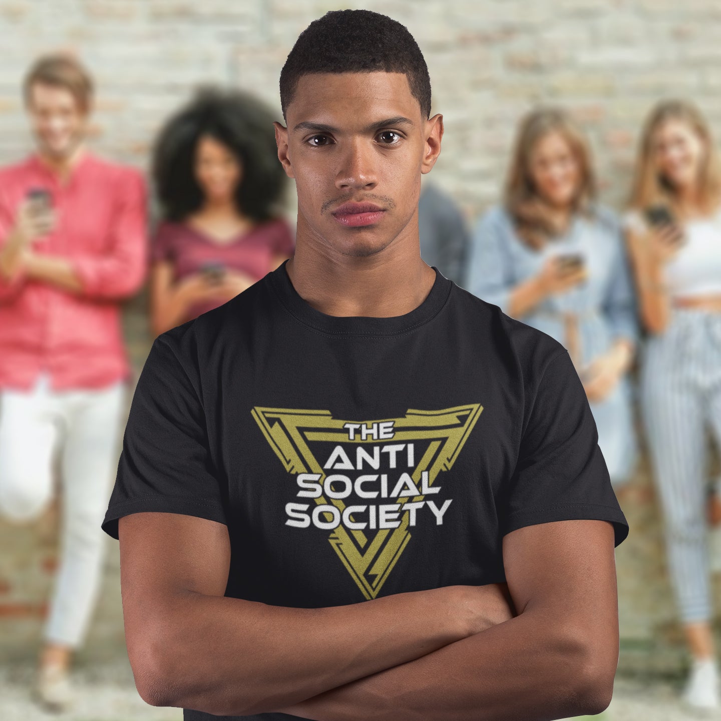 Person wearing a black t-shirt with 'The Anti Social Society' logo, standing in front of a blurred background of people using phones. This anti-social t-shirt design gives you an oxymoron to ponder, the more and more you don't want to be a member, the more you become one. A satirical counterculture dig at modern society Made from 100% organic ring-spun cotton, this social awareness t-shirt is unisex, high-quality, super comfy, and best of all, eco-friendly.