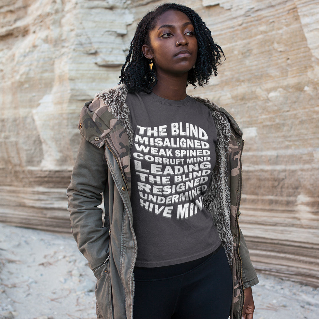 Person wearing a grey t-shirt with text standing against a stone wall. An anti government t shirt suggesting that it's not just a case of the blind leading the blind anymore. It's now a lot more complicated. Show your social awareness of a dysfunctional society with this political slogan design. Made from 100% organic ring-spun cotton, this dystopian t shirt design is unisex, high-quality, super comfy, and best of all, eco-friendly.