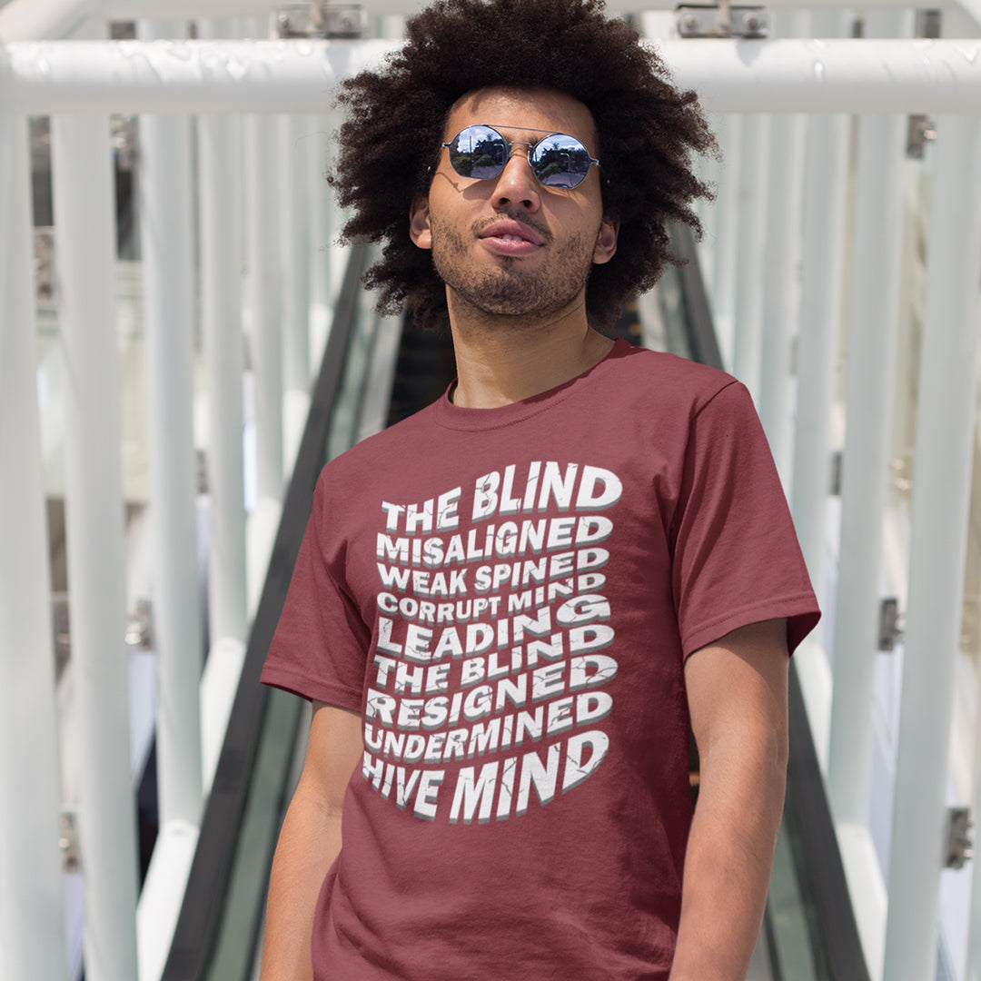 Man wearing a maroon t-shirt with text in an outdoor setting. An anti government t shirt suggesting that it's not just a case of the blind leading the blind anymore. It's now a lot more complicated. Show your social awareness of a dysfunctional society with this political slogan design. Made from 100% organic ring-spun cotton, this dystopian t shirt design is unisex, high-quality, super comfy, and best of all, eco-friendly.