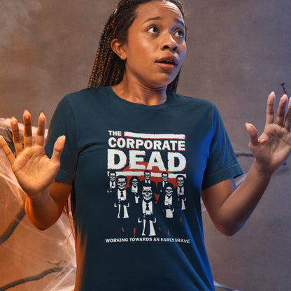 Person wearing a blue t-shirt with 'The Corporate Dead' graphic design. A satirical anti corporate t shirt in an old horror movie design suggesting that working for a corporation is a soulless task. they can be faster and more efficient than a regular zombie, but dead inside nonetheless. Made from 100% organic ring-spun cotton, this non conformist t shirt is unisex, high-quality, super comfy, and best of all, eco-friendly.