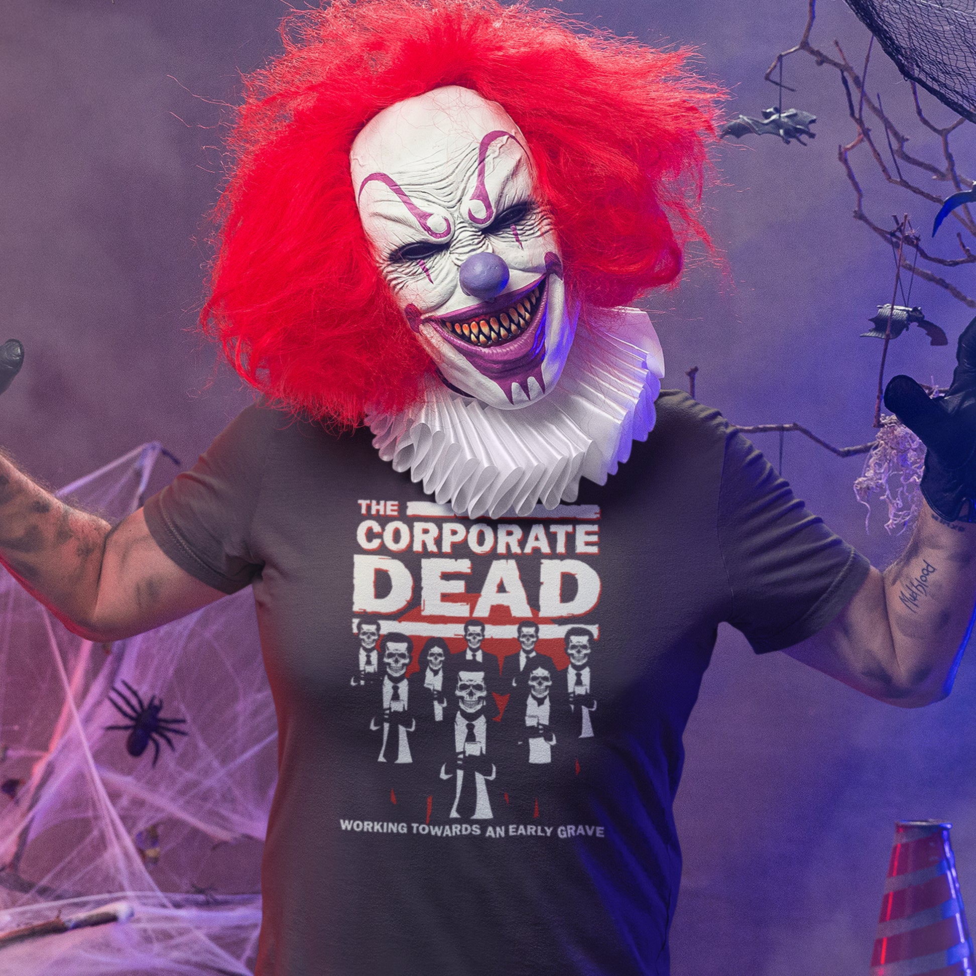 Person wearing a clown mask and a t-shirt with a graphic design in a Halloween-themed setting. A satirical anti corporate t shirt in an old horror movie design suggesting that working for a corporation is a soulless task. they can be faster and more efficient than a regular zombie, but dead inside nonetheless. Made from 100% organic ring-spun cotton, this non conformist t shirt is unisex, high-quality, super comfy, and best of all, eco-friendly.