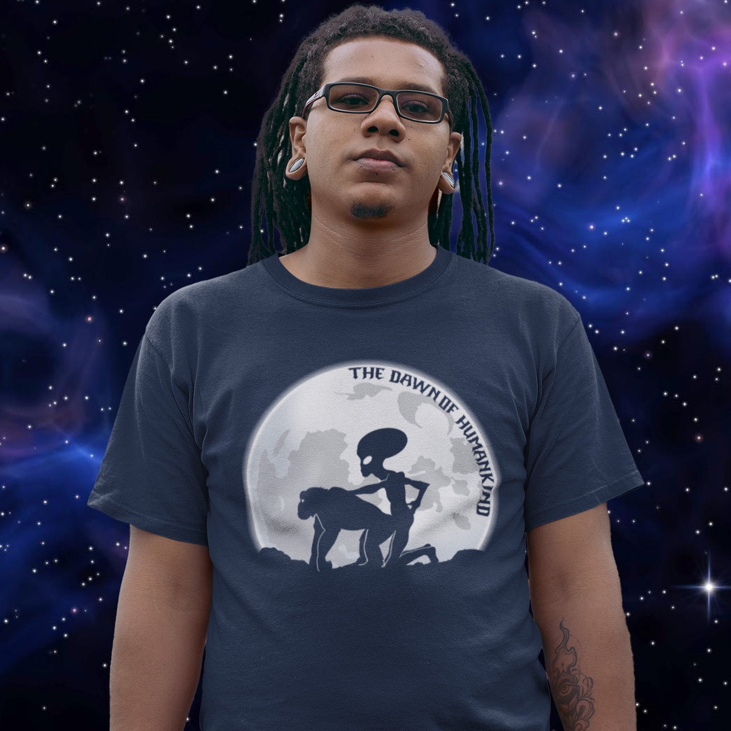 Person wearing a French navy blue t-shirt with a graphic design against a starry space background