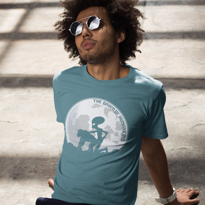 Man wearing a stargazer t-shirt with a graphic design, sitting on steps. A hilarious alien conspiracy theory t-shirt depicting an one alternative reason for the evolution of humankind on this planet. One of many possibilities as to our origins and why there is such a great distance between us and the rest of the animal kingdom. Made from 100% organic ring-spun cotton, this conspiracy theory t-shirt is unisex, high-quality, super comfy, and best of all, eco-friendly.