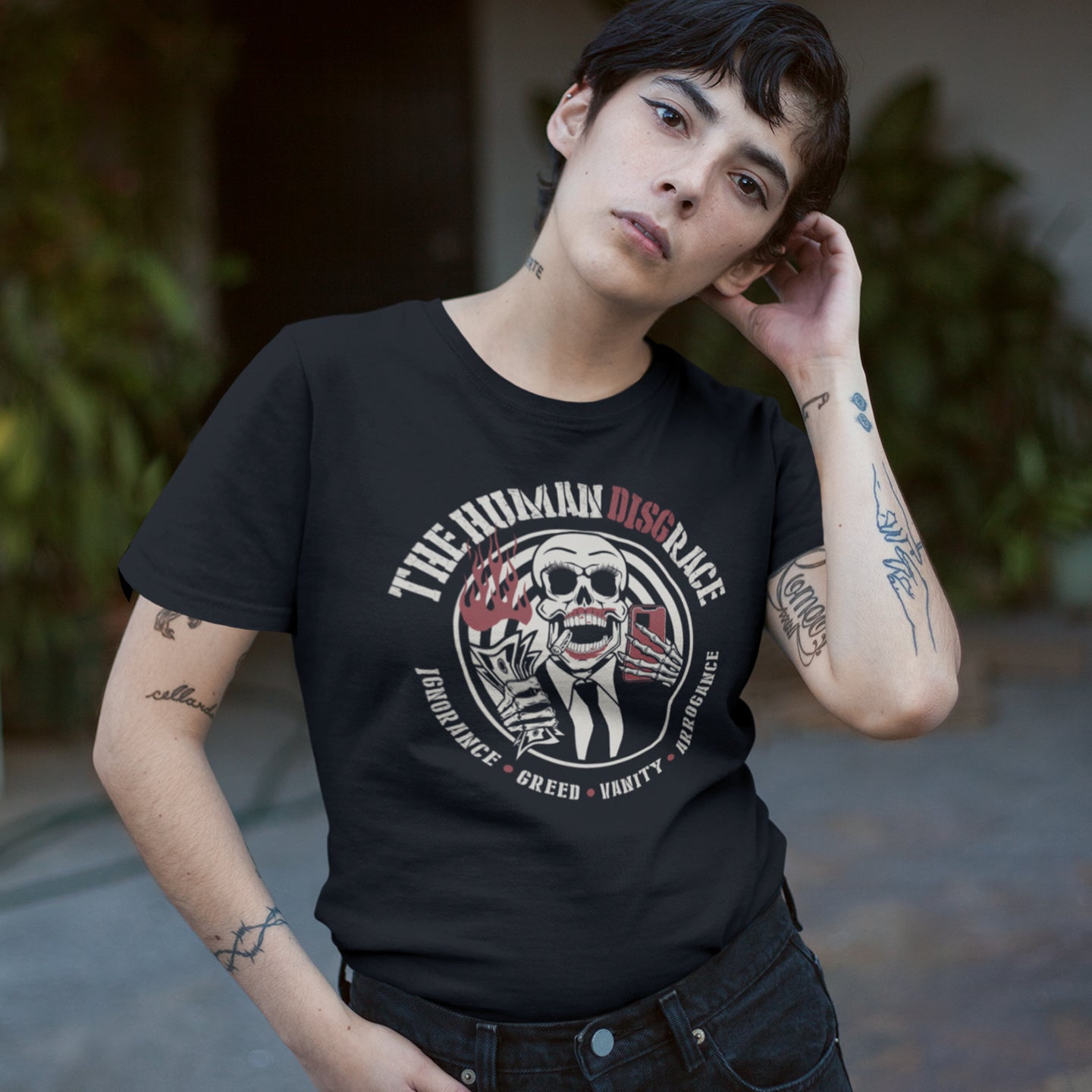 Person wearing a black t-shirt with a graphic design and text. This broken society t shirt exposes the dark side of people. A great urban art design if you believe the human race has descended into a disgrace and we need educating about our own weaknesses before it's too late. Made from 100% organic ring-spun cotton, these social issues t shirts are unisex, high quality, super comfy, and best of all, eco-friendly.