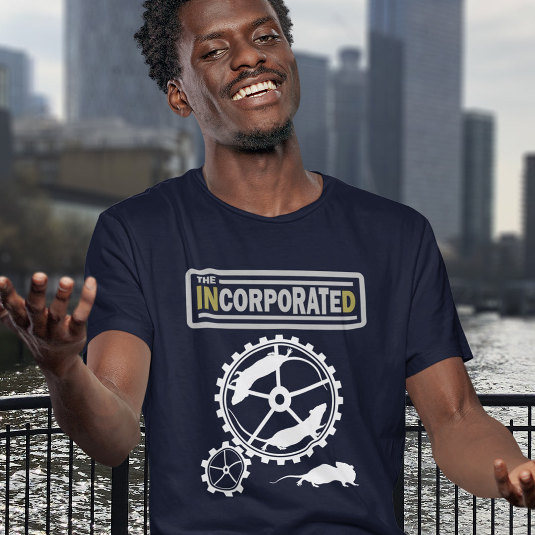 Man wearing a 'Incorporated' text t shirt, standing outdoors. This non conformist design questions the effects of a corporate run society in the form of a spoof rock band t shirt. Have we just created a corporate cult to follow ? A satirical and alternative view of the modern rat race. Made from 100% organic ring-spun cotton, this counter culture t shirt is unisex, high-quality, super comfy, and best of all, eco-friendly.