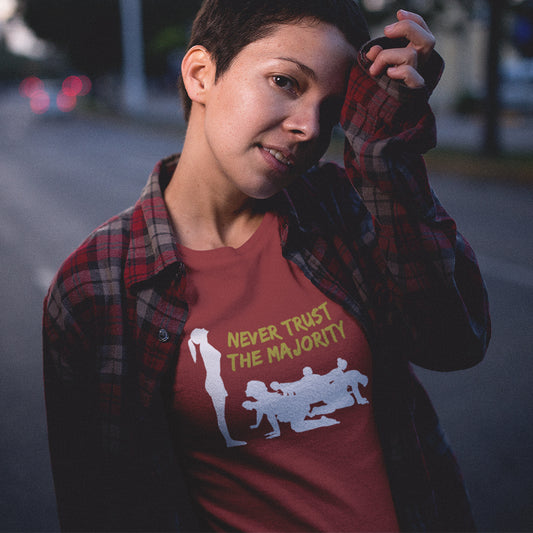 Person wearing a red t-shirt, standing on a street at night. This self worth t shirt promotes independent thought. In this era of manipulation, indoctrination, misinformation and gaslighting, you have to think twice before believing what the majority of people think. Promote independent thinking and diversity with this satirical 'think outside the box' design. Made from 100% organic ring-spun cotton, this non conformist t shirt is unisex, high quality, super comfy, and best of all, eco-friendly.