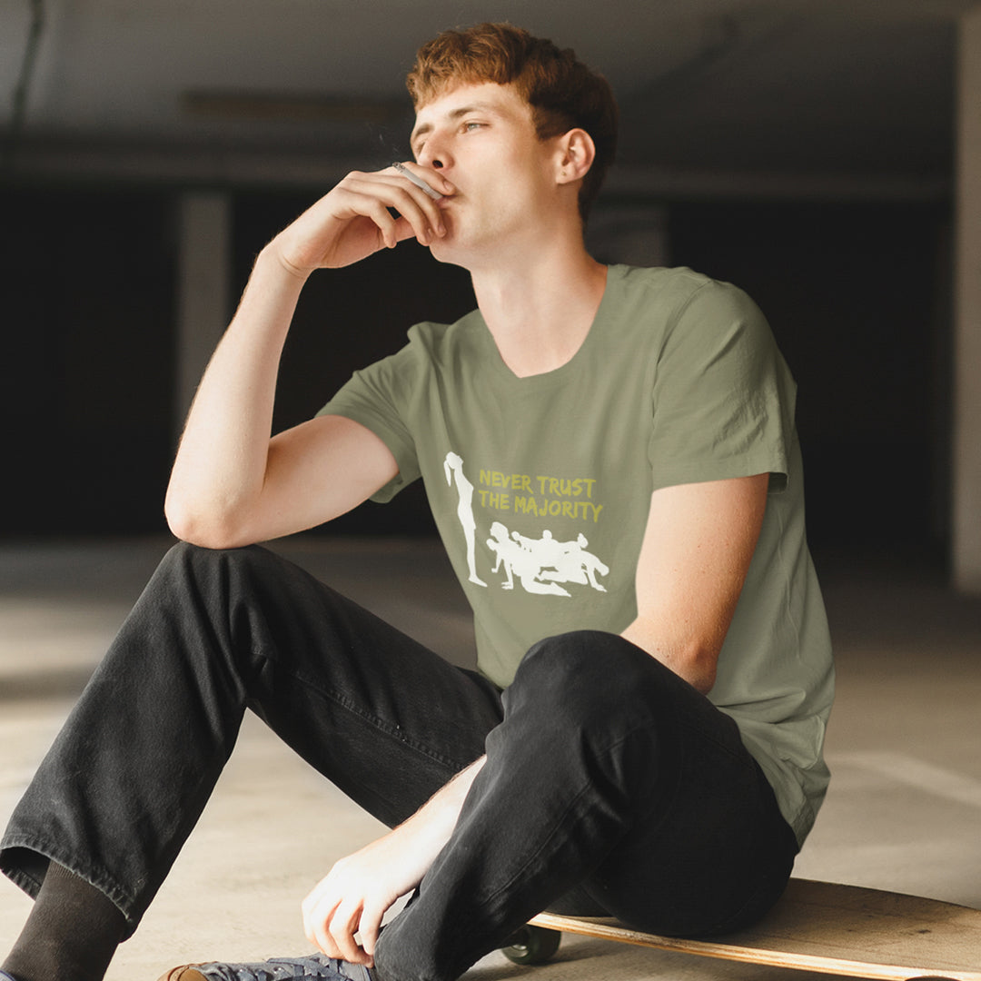 Person wearing a green t-shirt, sitting on a skateboard. This self worth t shirt promotes independent thought. In this era of manipulation, indoctrination, misinformation and gaslighting, you have to think twice before believing what the majority of people think. Promote independent thinking and diversity with this satirical 'think outside the box' design. Made from 100% organic ring-spun cotton, this non conformist t shirt is unisex, high quality, super comfy, and best of all, eco-friendly.