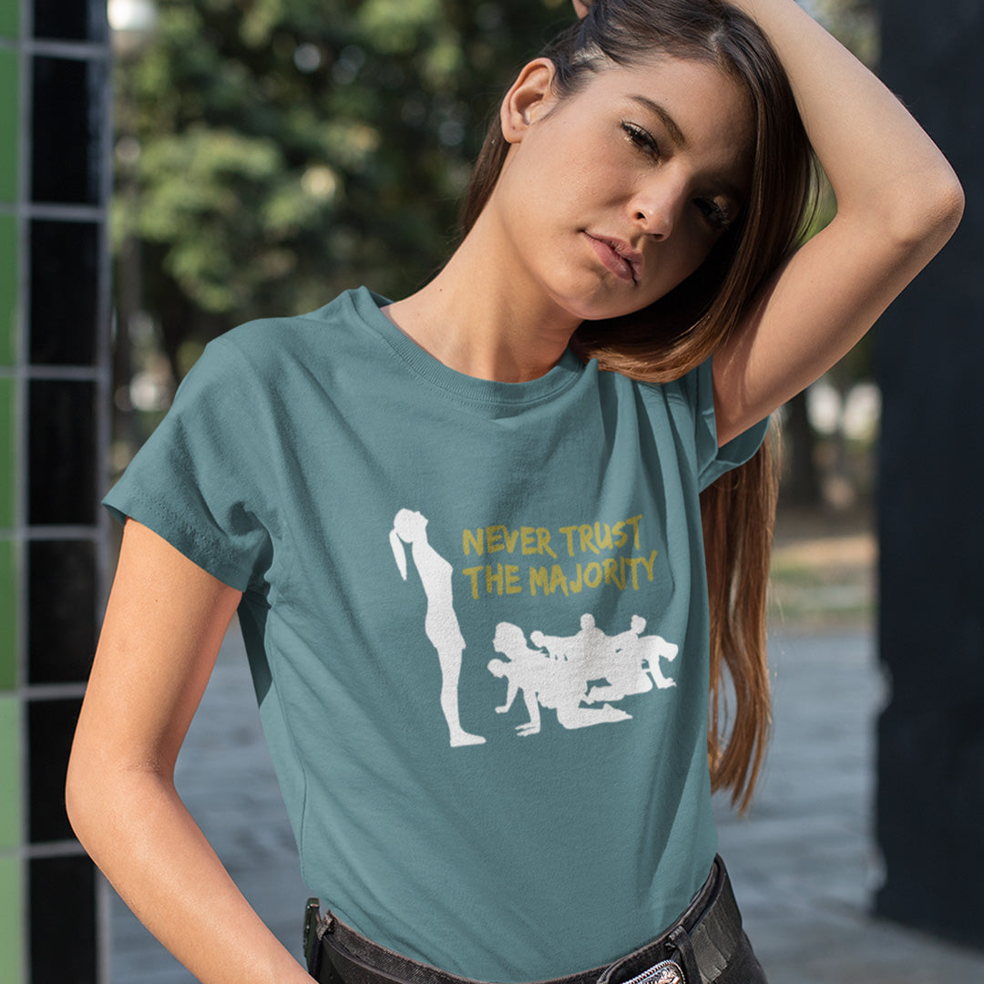 Woman wearing a teal t-shirt with graphic design and text outdoors. This self worth t shirt promotes independent thought. In this era of manipulation, indoctrination, misinformation and gaslighting, you have to think twice before believing what the majority of people think. Promote independent thinking and diversity with this satirical 'think outside the box' design. Made from 100% organic ring-spun cotton, this non conformist t shirt is unisex, high quality, super comfy, and best of all, eco-friendly.