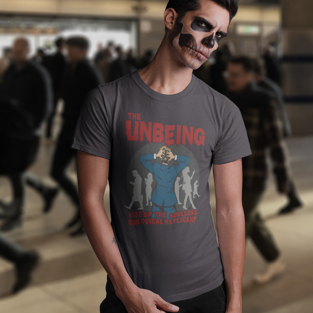 Person wearing a t-shirt with 'The Unbeing' graphic design.AA broken society t shirt design twisted into a spoof 1970's horror movie poster. This design accuses modern life of turning people into soulless non beings roaming the streets with their heads in a different space to their bodies . Vintage horror movie style with a modern threat to society. Made from 100% organic ring-spun cotton, this anti mobile phone abuse t shirt is unisex, high-quality, super comfy, and best of all—eco-friendly.