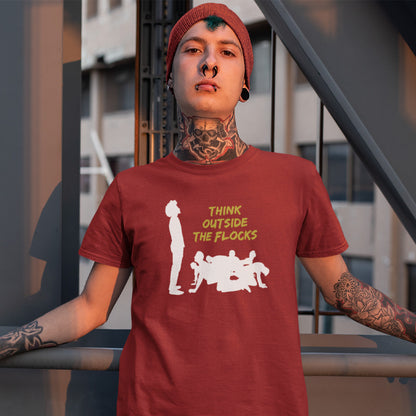 A person wearing a maroon short-sleeve graphic T-shirt with a white silhouette print and yellow text reading 'THINK OUTSIDE THE FLOCKS,' photographed against an urban staircase background.