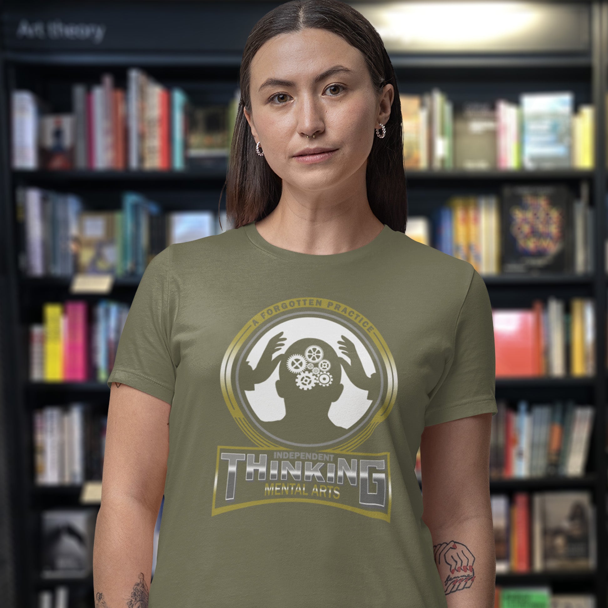 Person wearing a green t-shirt with a graphic design in a bookstore. A sign of the times t shirt suggesting independent thinking is a forgotten art since we let machines think for us. Promote independent thinking with this some what sarcastic t-shirt. Made from 100% organic ring-spun cotton, this urban art t shirt is unisex, high-quality, super comfy, and best of all, eco-friendly.