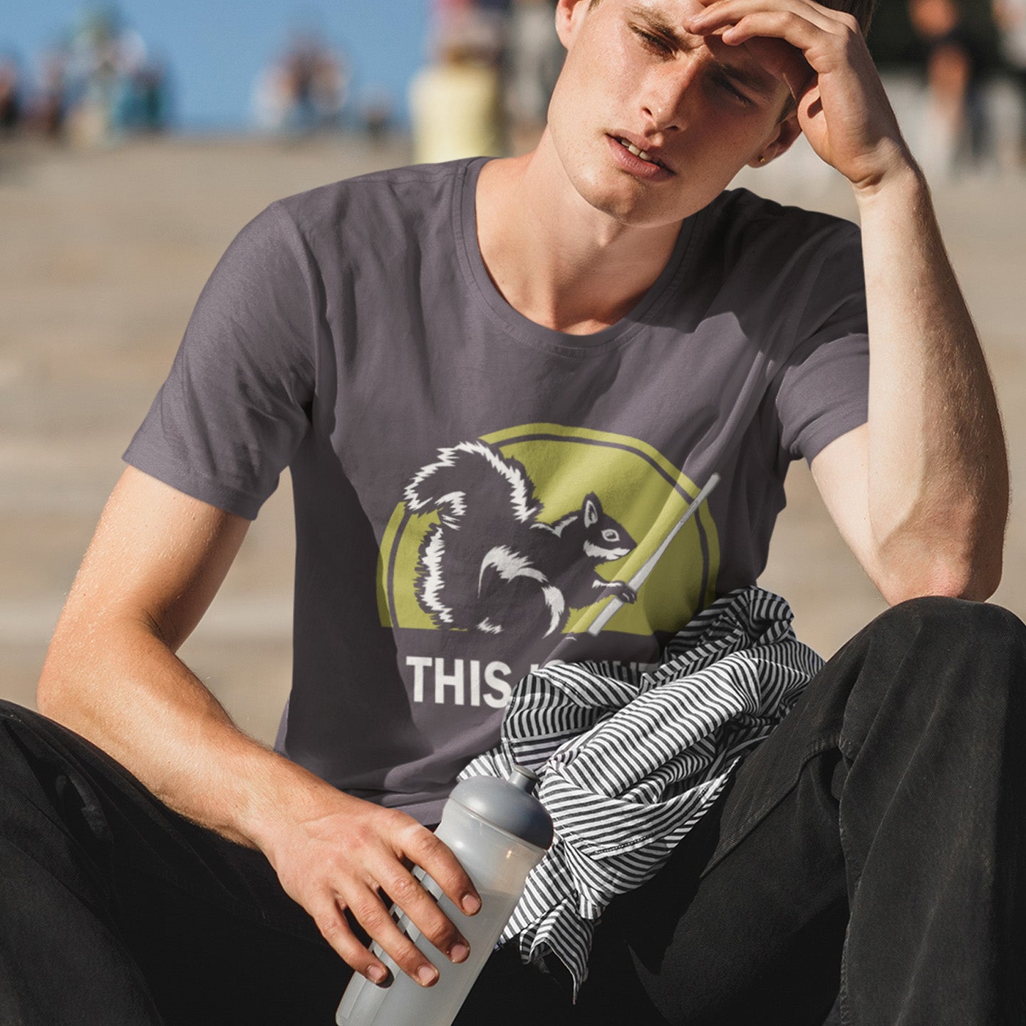 Man sitting outdoors wearing a t-shirt with a graphic design and text. A funny anti mobile phone abuse t shirt. Just about everyone is glued to a mobile phone these days. It's crazy. Increase social awareness of over use with this unique design. Made from 100% organic ring-spun cotton, this anti smart phone abuse t-shirt design is unisex, high-quality, super comfy, and best of all, eco-friendly.