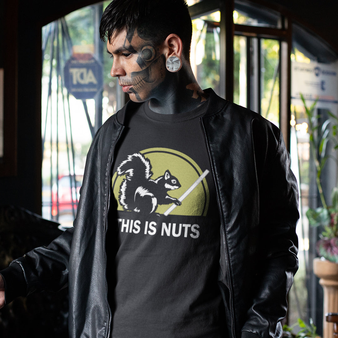 Person wearing a black t-shirt with a graphic design and text, standing indoors. A funny anti mobile phone abuse t shirt. Just about everyone is glued to a mobile phone these days. It's crazy. Increase social awareness of over use with this unique design. Made from 100% organic ring-spun cotton, this anti smart phone abuse t-shirt design is unisex, high-quality, super comfy, and best of all, eco-friendly.