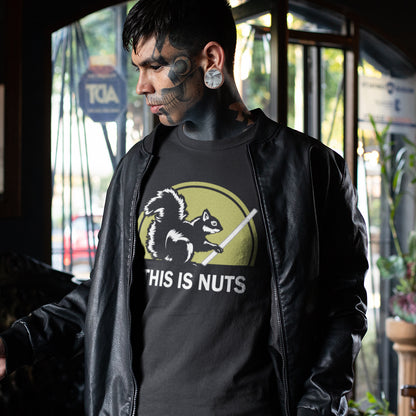 Person wearing a black t-shirt with a graphic design and text, standing indoors. A funny anti mobile phone abuse t shirt. Just about everyone is glued to a mobile phone these days. It's crazy. Increase social awareness of over use with this unique design. Made from 100% organic ring-spun cotton, this anti smart phone abuse t-shirt design is unisex, high-quality, super comfy, and best of all, eco-friendly.