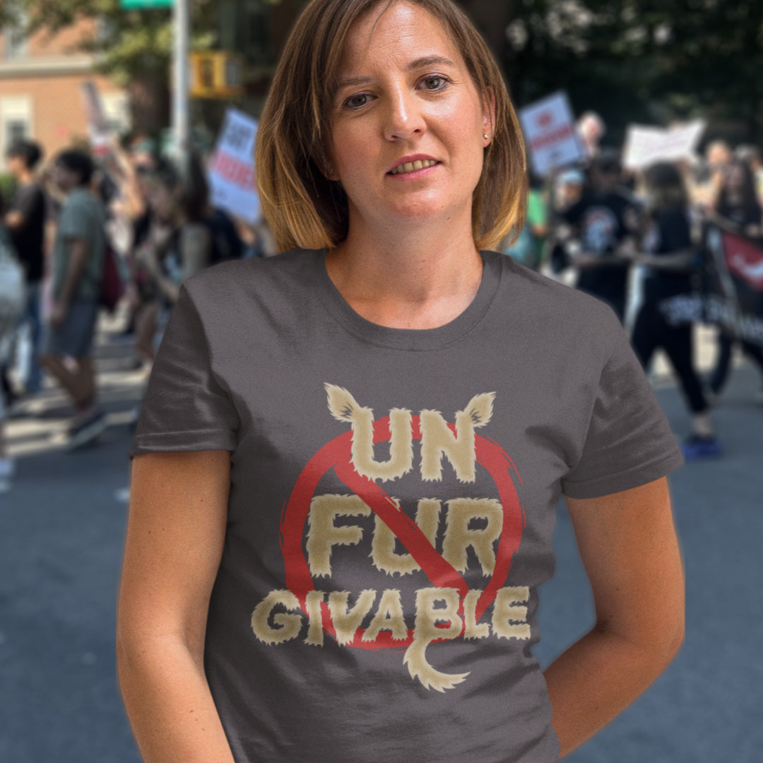 Woman wearing a t-shirt with 'Un Fur Givable' text at a protest event. This animal rights t shirt is anti fur and suggests the wearing of fur as unforgivable. Show your support against an unnecessary industry that promotes suffering and slaughter. Made from 100% organic ring-spun cotton, these animal activist t shirts are unisex, high-quality, super comfy, and best of all, eco-friendly.