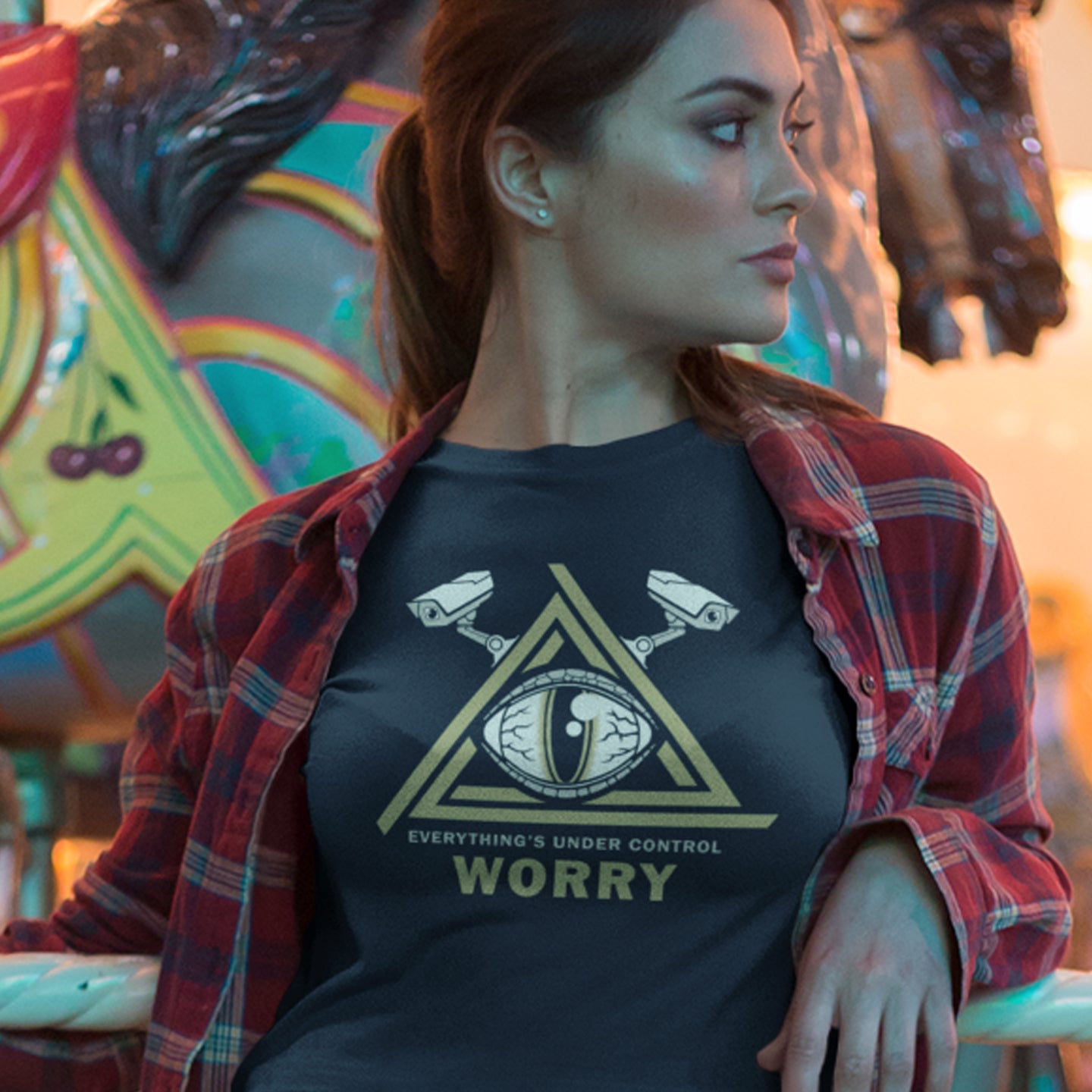 Woman wearing a t-shirt with a graphic design and text, standing in front of a colourful carousel. A conspiracy theory t-shirt for all that see paranoia as a necessity. This design is a must if your imagination is colourful enough to believe we are being controlled by reptilian alien overlords. Made from 100% organic ring-spun cotton, this alien conspiracy theory t-shirt is unisex, high-quality, super comfy, and best of all, eco-friendly.