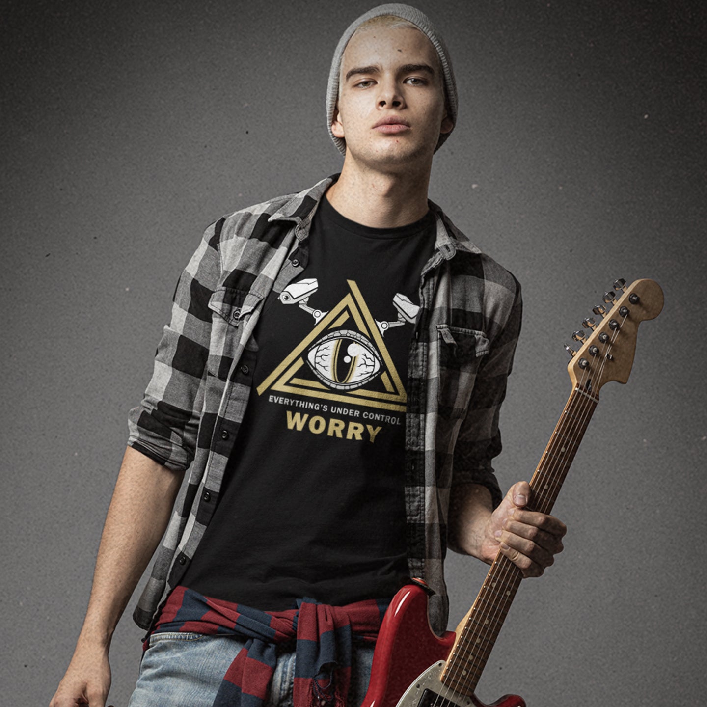 Person holding a guitar wearing a black t-shirt with graphic design.  A conspiracy theory t-shirt for all that see paranoia as a necessity. This design is a must if your imagination is colourful enough to believe we are being controlled by reptilian alien overlords. Made from 100% organic ring-spun cotton, this alien conspiracy theory t-shirt is unisex, high-quality, super comfy, and best of all, eco-friendly.