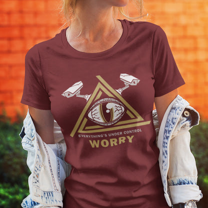 Person wearing a burgundy t-shirt with a graphic design and text in front of an orange wall. A conspiracy theory t-shirt for all that see paranoia as a necessity. This design is a must if your imagination is colourful enough to believe we are being controlled by reptilian alien overlords. Made from 100% organic ring-spun cotton, this alien conspiracy theory t-shirt is unisex, high-quality, super comfy, and best of all, eco-friendly.