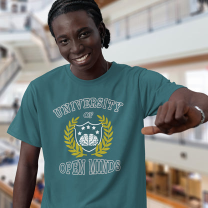 Person wearing a teal t-shirt with 'University of Open Minds' design in an indoor setting. A cool graphic design for the liberal minded. If you think outside the box then this university is for you. Only practical lessons and no student loan required. Made from 100% organic ring-spun cotton, this social awareness t-shirt is unisex, high-quality, super comfy, and best of all, eco-friendly.