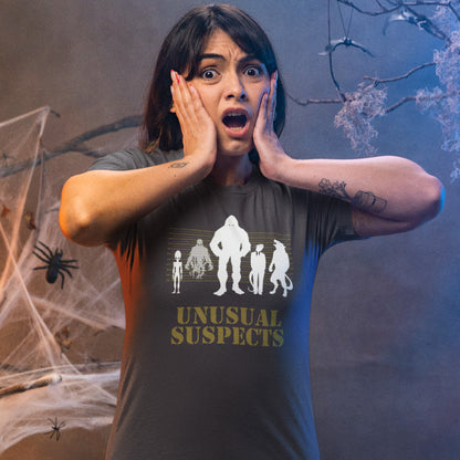 Person wearing a 'Unusual Suspects' t-shirt with a Halloween-themed background. A conspiracy theorist t shirt for movie lovers. From bigfoot to aliens, these are the personnel responsible for most cover ups and disputed existences. This imaginative stencil art design is for people who think outside the box. Made from 100% organic ring-spun cotton, this witty conspiracy theory t-shirt is unisex, high-quality, super comfy, and best of all, eco-friendly.