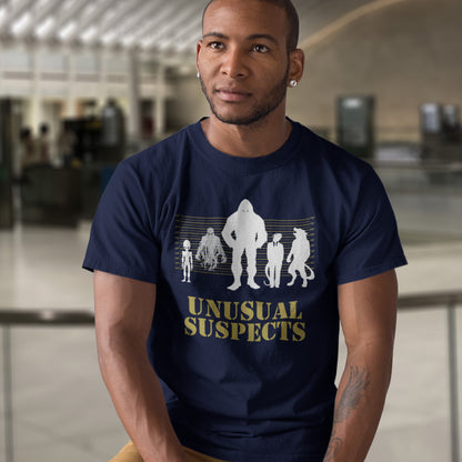 Man wearing a French navy blue t-shirt with 'Unusual Suspects' graphic design in an indoor setting. A conspiracy theorist t shirt for movie lovers. From bigfoot to aliens, these are the personnel responsible for most cover ups and disputed existences. This imaginative stencil art design is for people who think outside the box.&nbsp;Made from 100% organic ring-spun cotton, this witty conspiracy theory t-shirt is unisex, high-quality, super comfy, and best of all, eco-friendly.