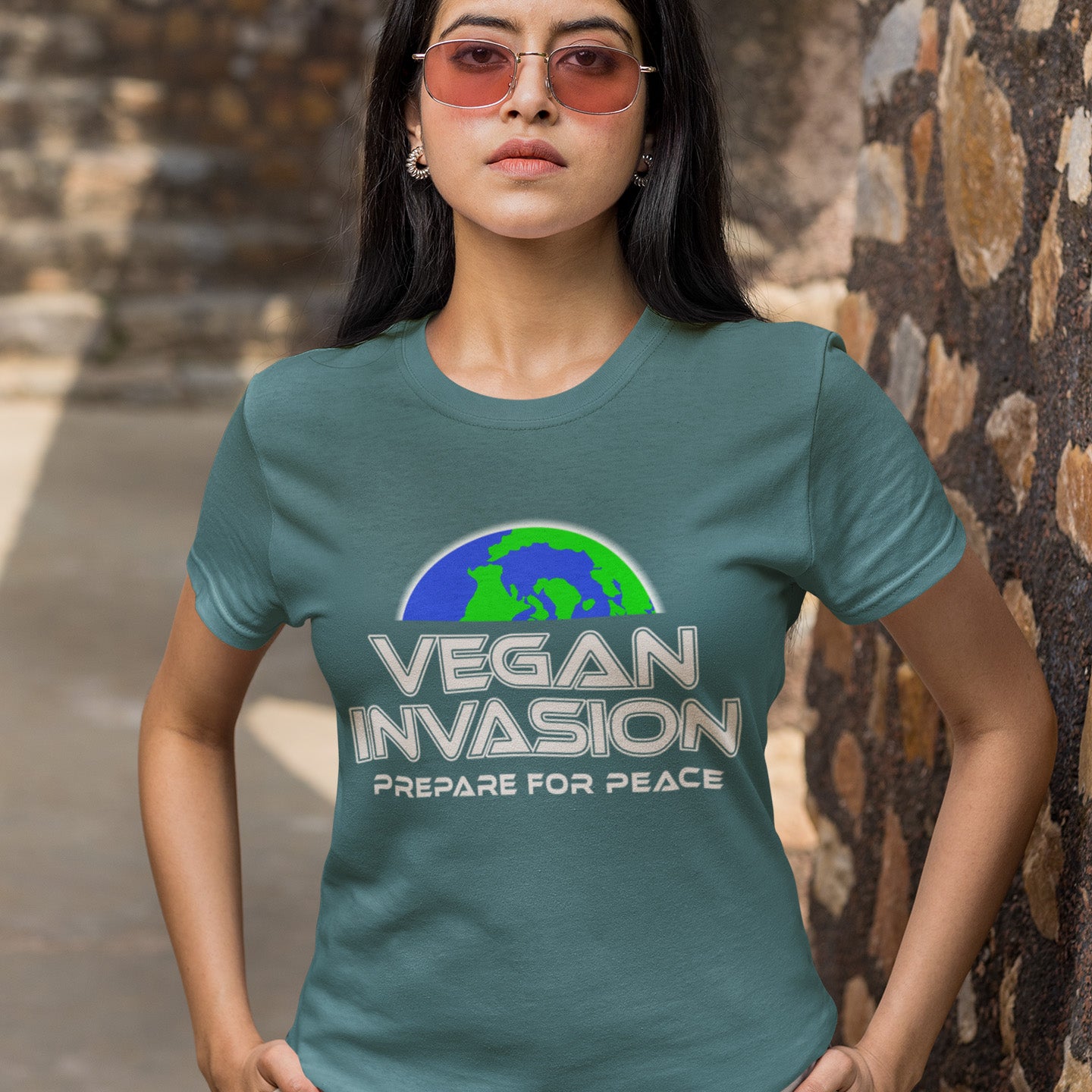 Person wearing a stargazer t-shirt with 'Vegan Invasion: Prepare for Peace' text and graphic. This vegan meat free t shirt design plays on the idea that other people view vegans as alien. Reassure people that you are a peaceful creature and remind them that you help to save the planet. Made from 100% organic ring-spun cotton, this plant based meat free t shirt is unisex, high-quality, super comfy, and best of all, eco-friendly.