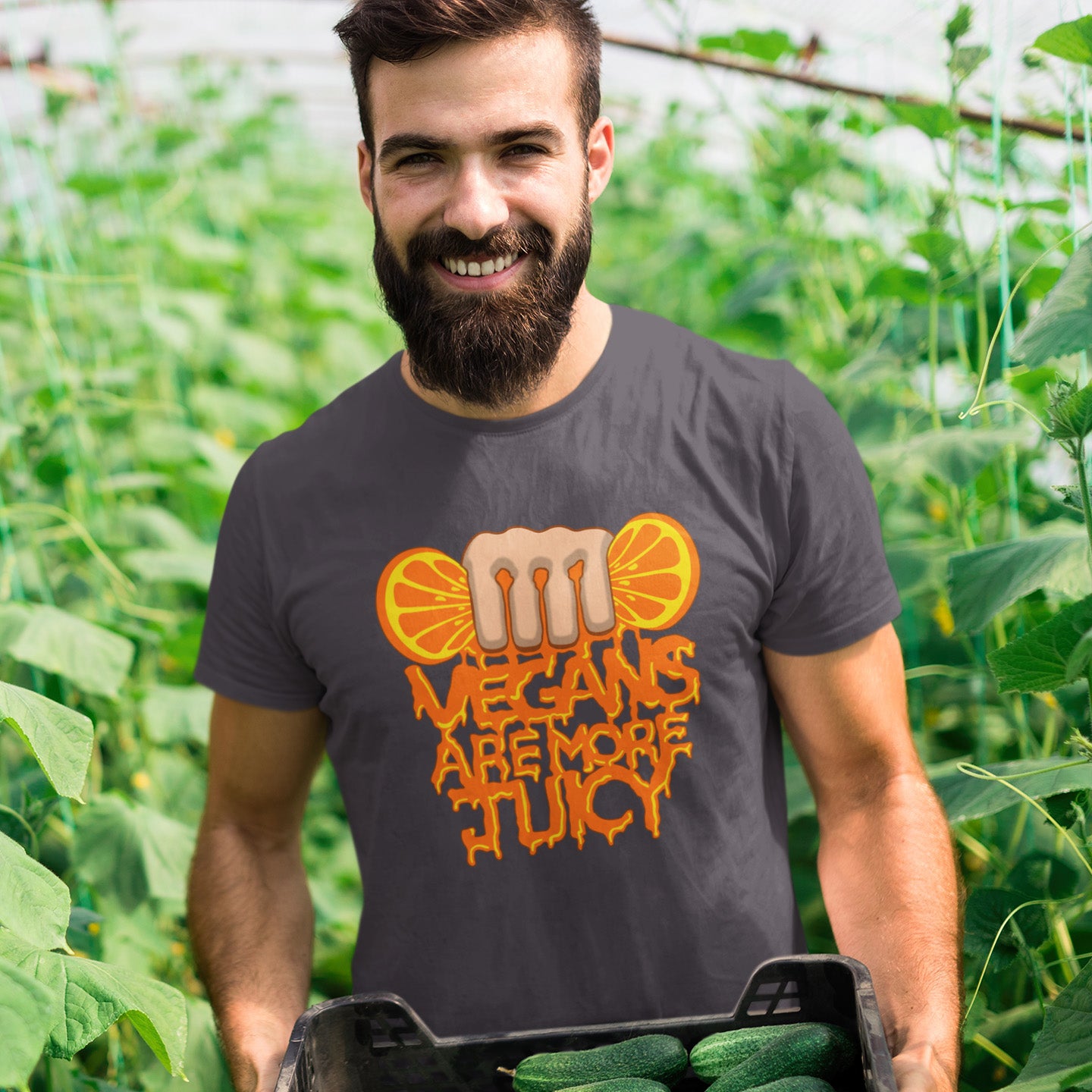Man wearing a t-shirt with 'Vegans are more juicy' design in a garden setting. A plant based meat free t shirt design suggesting vegans drink more juices than most. Made from 100% organic ring-spun cotton, this vegan dairy free t shirt is unisex, high-quality, super comfy, and best of all, eco-friendly.