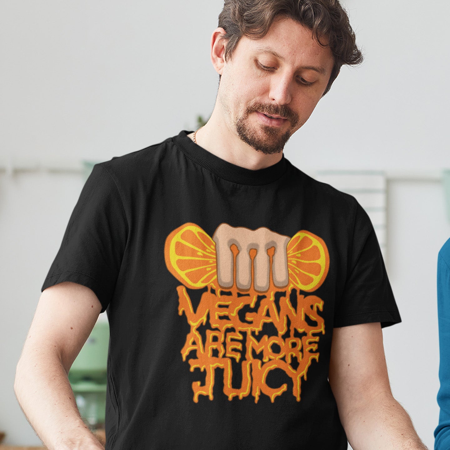 Person wearing a black t-shirt with a graphic design and text. A plant based meat free t shirt design suggesting vegans drink more juices than most. Made from 100% organic ring-spun cotton, this vegan dairy free t shirt is unisex, high-quality, super comfy, and best of all, eco-friendly.