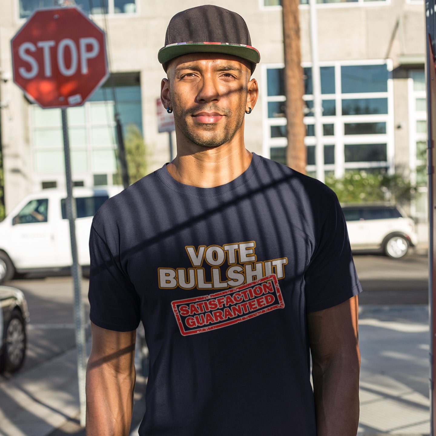 Man wearing a French navy t-shirt with a humorous message, standing on a city street. This anti government t-shirt design tells it like it is. This unique anti establishment t shirt is for those who have lost all faith in politics. It seems no matter what you vote for, you definitely get bullshit. Made from 100% organic ring-spun cotton, this anti government t shirt is unisex, high-quality, super comfy, and best of all, eco-friendly.