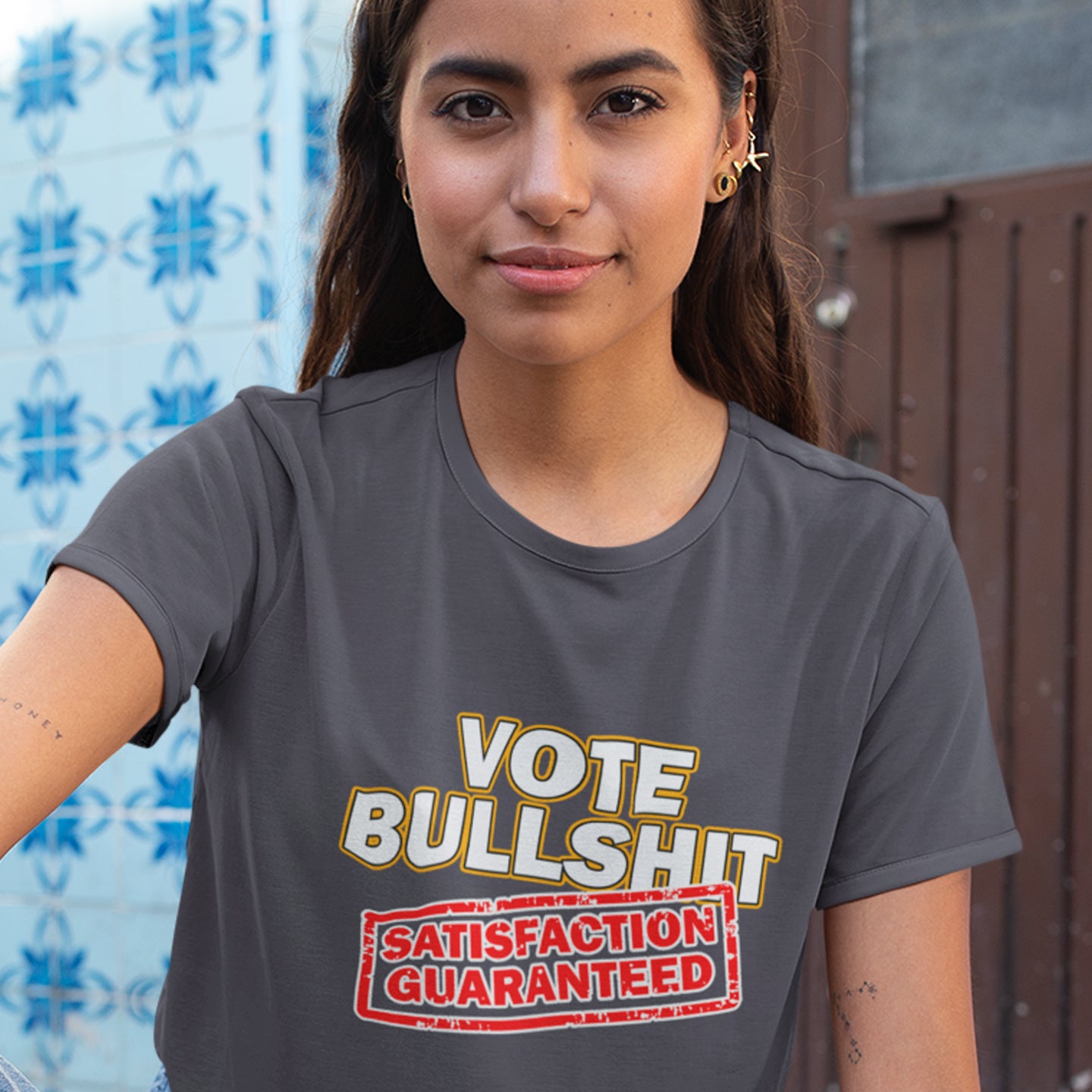Person wearing an anthracite t-shirt with a humorous graphic design. This political t-shirt design tells it like it is. This unique anti-establishment t-shirt is for those who have lost all faith in politics. It seems no matter what you vote for, you definitely get bullshit. Made from 100% organic ring-spun cotton, this anti-government t-shirt is unisex, high-quality, super comfy, and best of all, eco-friendly.