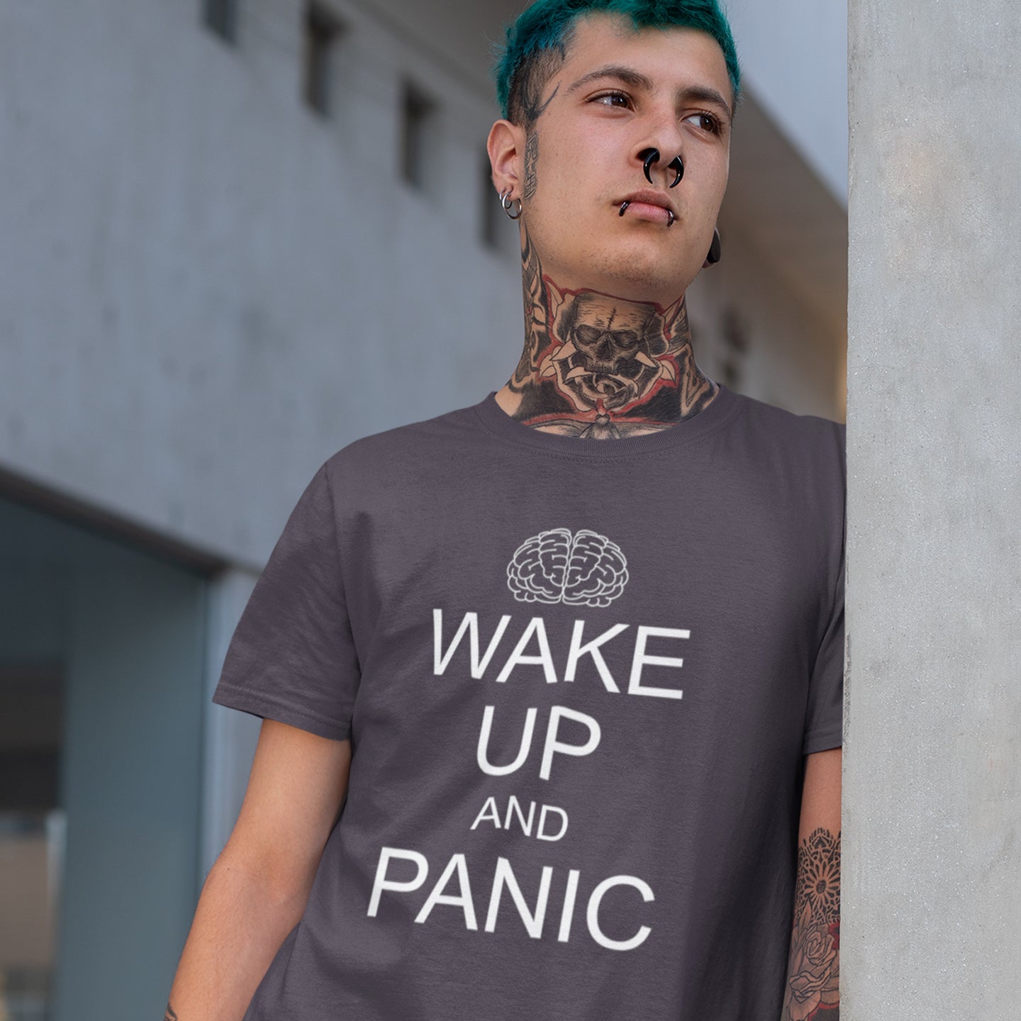 Person wearing a t-shirt with 'Wake Up and Panic' text and brain graphic. This satirical 'stay calm' anti-establishment t-shirt suggests we have been calm too long and need of waking up and panic. Keeping calm got us into this mess, it's time to wake up. 100% organic ring-spun cotton, this anti-government t-shirt is unisex, high-quality, super comfy, and best of all, eco-friendly.