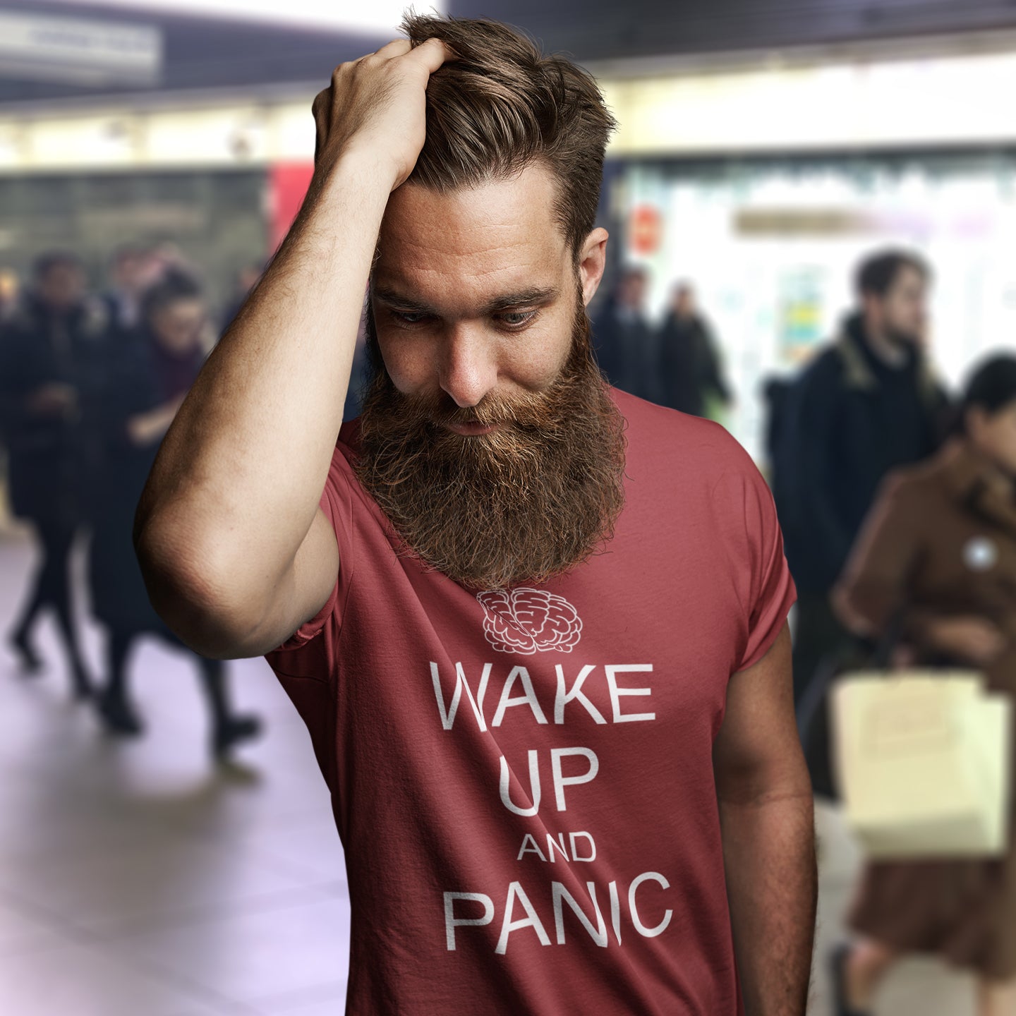 Man wearing a burgundy t-shirt with 'Wake Up and Panic' text in a busy subway setting. This satirical 'stay calm' anti-establishment t-shirt suggests we have been calm too long and need of waking up and panic. Keeping calm got us into this mess, it's time to wake up. 100% organic ring-spun cotton, this anti-government t-shirt is unisex, high-quality, super comfy, and best of all, eco-friendly.