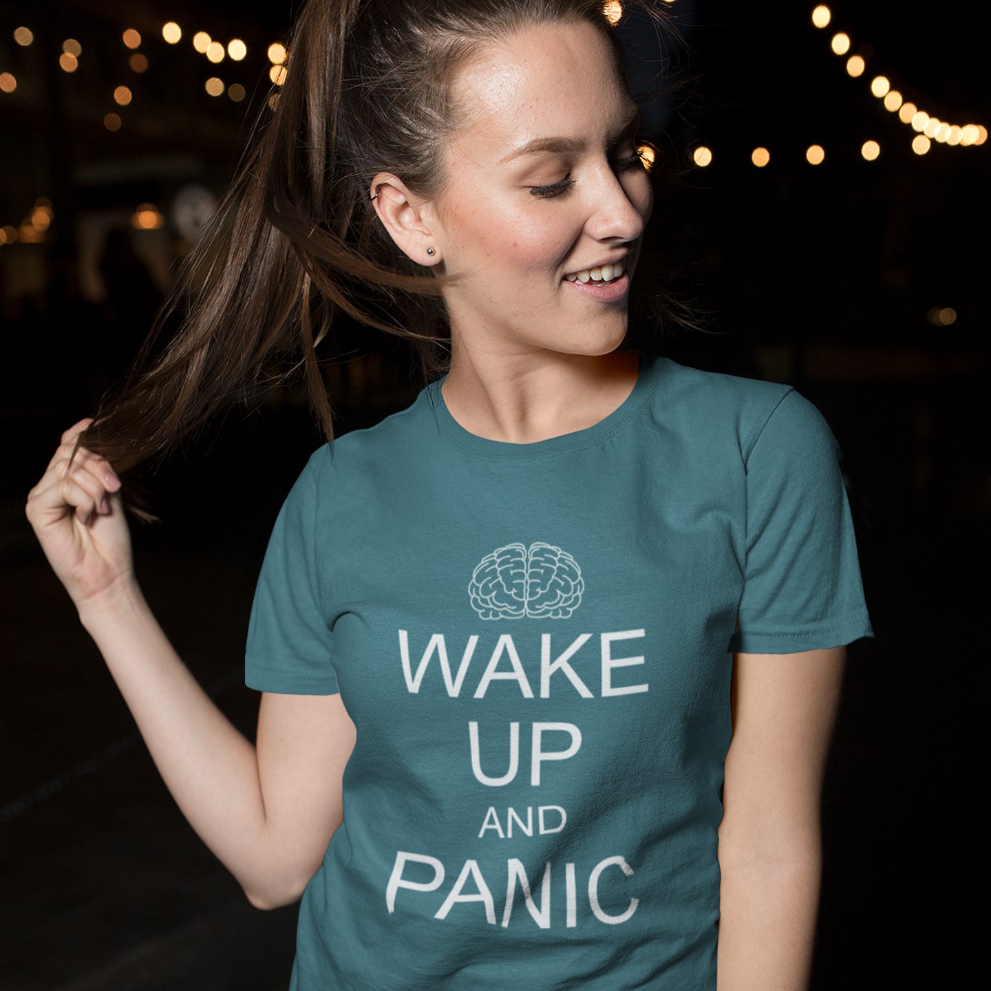 Woman wearing a stargazer t-shirt with 'Wake Up and Panic' text and brain graphic. This satirical 'stay calm' anti-establishment t-shirt suggests we have been calm too long and need of waking up and panic. Keeping calm got us into this mess, it's time to wake up. 100% organic ring-spun cotton, this anti-government t-shirt is unisex, high-quality, super comfy, and best of all, eco-friendly.