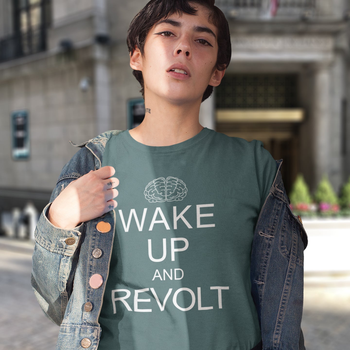 Person wearing a stargazer t-shirt with 'Wake Up and Revolt' text and a brain graphic. This satirical 'stay calm' t-shirt suggests we have been calm too long and need of waking up and fighting for our right instead. Keeping calm got us into this mess, it's time to wake up. Made from 100% organic ring-spun cotton, this counterculture t-shirt is unisex, high-quality, super comfy, and best of all, eco-friendly.