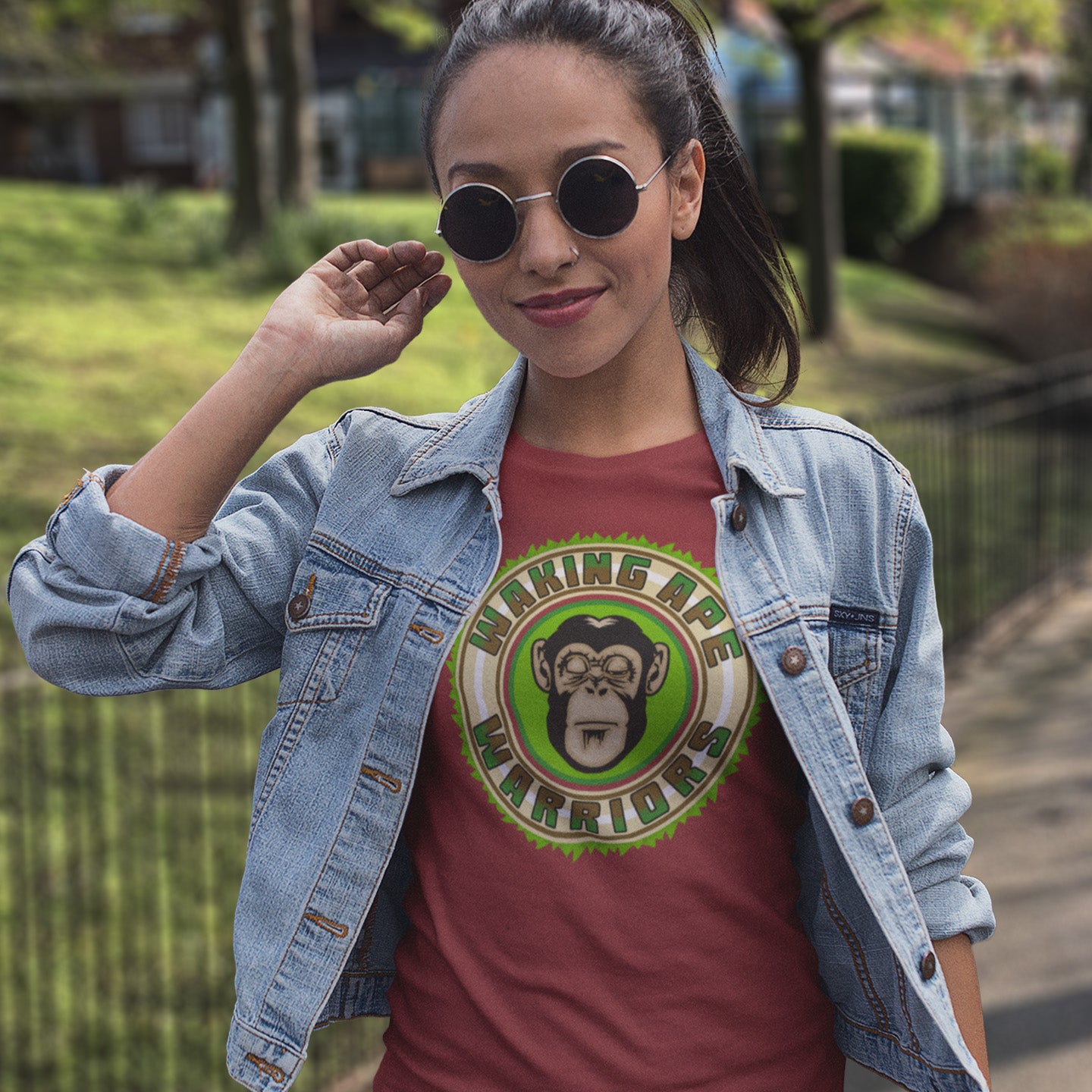 Woman wearing a denim jacket and red t-shirt with a graphic design outdoors. The message that comes with this original save the planet t shirt design is one of resistance to concrete jungles, processed food and plastic people. Ideal for anyone with environmental concern or any doubts about an A.I take over. Awaken your inner primate. Made from 100% organic ring-spun cotton, this save the Earth t shirt is unisex, high-quality, super comfy, and best of all, eco-friendly.