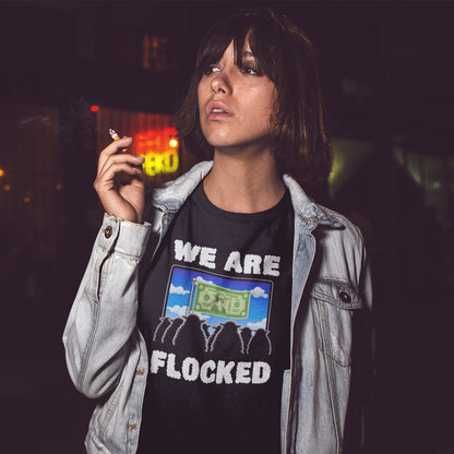 Woman smoking at night, wearing a "we are flocked" t shirt. A funny broken society t shirt depicting people as a flock of sheep obsessed with money and screens. This urban art design uses Satirical humour to address the direction of our society, and the main forces of attraction in it. Made from 100% organic ring-spun cotton, these social issues t shirts are unisex, high quality, super comfy, and best of all, eco-friendly.