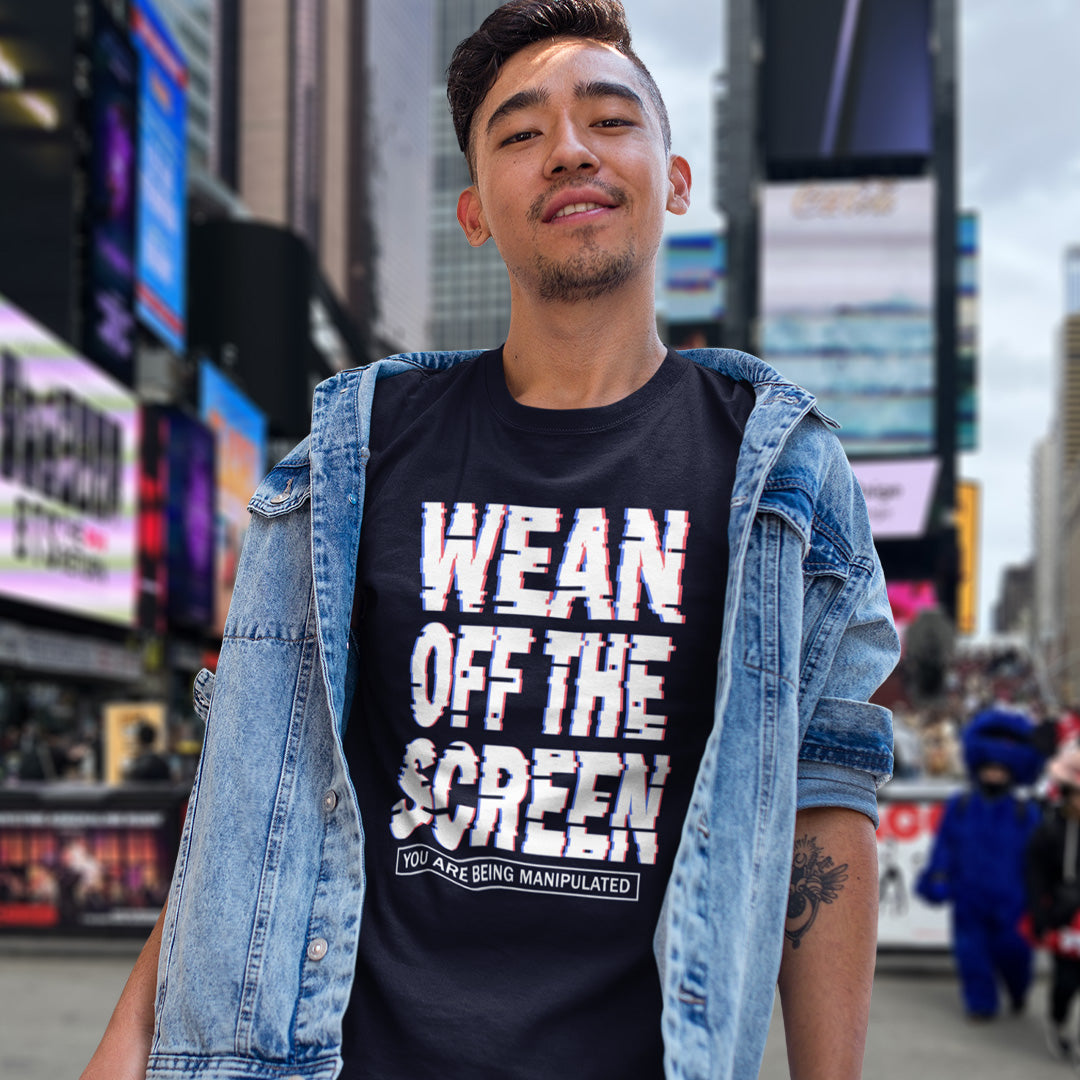 Man wearing a French navy t-shirt with text in Times Square, New York City. This media based conspiracy theory t-shirt suggests there is more to digital media and entertainment than meets the eye. An anti mobile abuse slogan in a unique design to increase social awareness of too much screen time. Made from 100% organic ring-spun cotton, this conspiracy theory t-shirt is unisex, high-quality, super comfy, and best of all, eco-friendly.