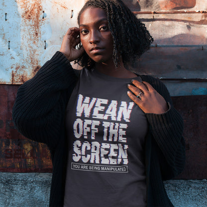 Person wearing a t-shirt with text 'Wean Off The Screen' against a rustic wall. This media based conspiracy theory t-shirt suggests there is more to digital media and entertainment than meets the eye. An anti mobile abuse slogan in a unique design to increase social awareness of too much screen time. Made from 100% organic ring-spun cotton, this conspiracy theory t-shirt is unisex, high-quality, super comfy, and best of all, eco-friendly.