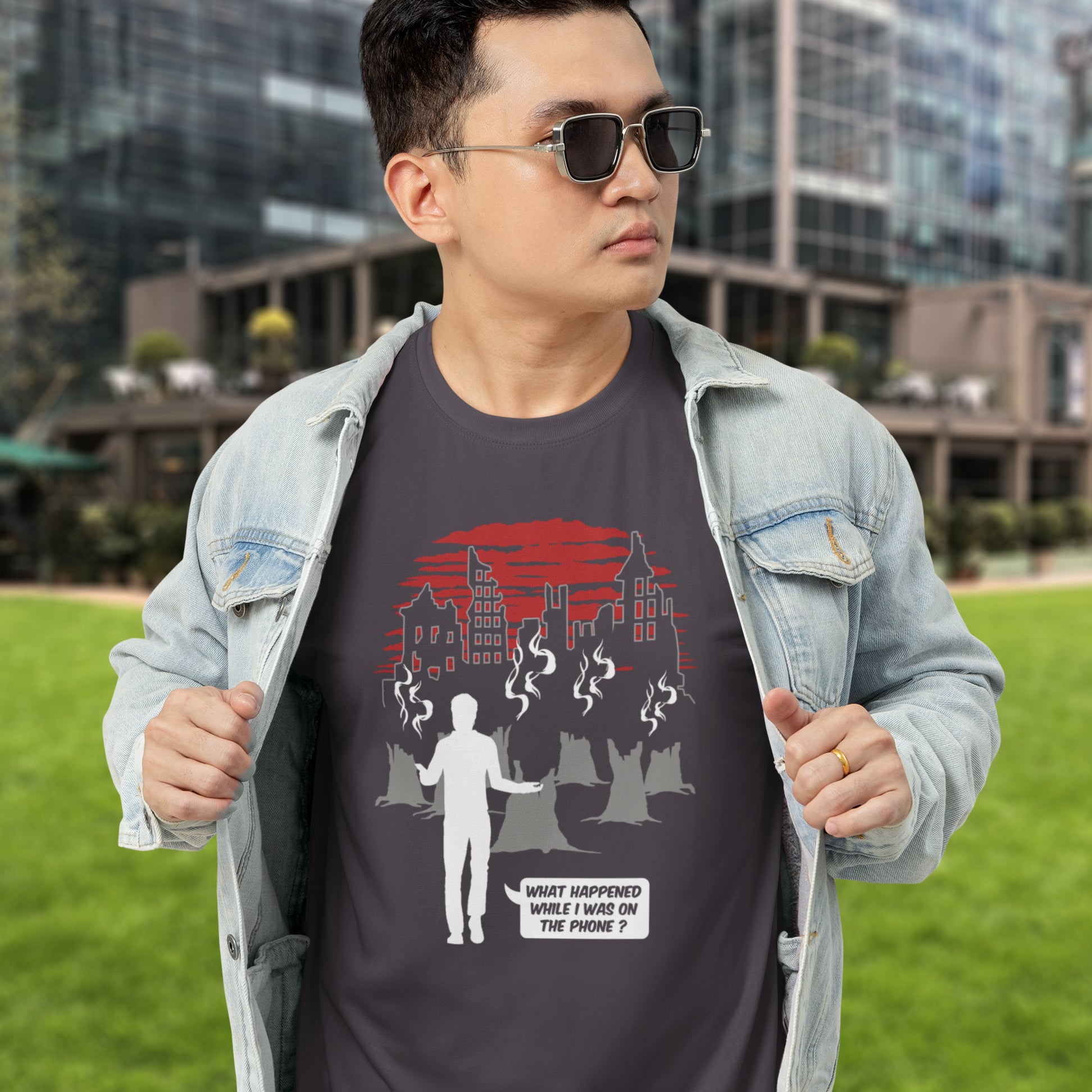 Man wearing a dark t-shirt with a graphic design outdoors. This environmental concern t-shirt asks the question Is the mobile phone the ultimate distraction from the real issues going on in the World. Let's put down the phone and save the planet. Climate concern is not an app. Made from 100% organic ring-spun cotton, this social awareness &amp; environmental concern t-shirt is unisex, high-quality, super comfy, and best of all, eco-friendly.