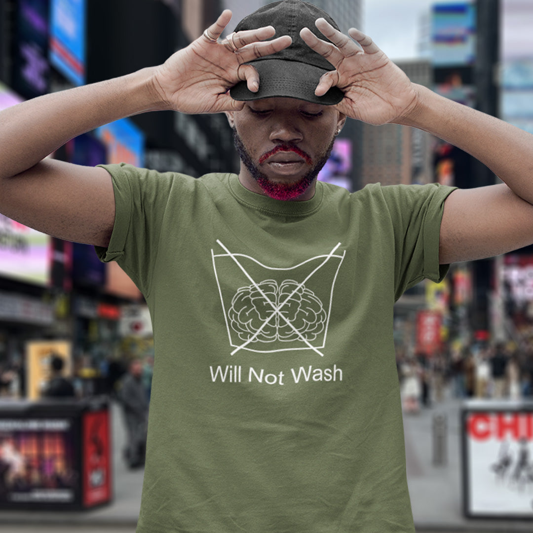 Man standing in Time Square. A self worth t shirt promoting a strong mind and a resistance to brainwashing. this unique anti-establishment t-shirt design is a play on washing instructions and highlights the mass influence and indoctrination in modern society. Made from 100% organic ring-spun cotton, this clever slogan t shirt is unisex, high-quality, super comfy, and best of all, eco-friendly.