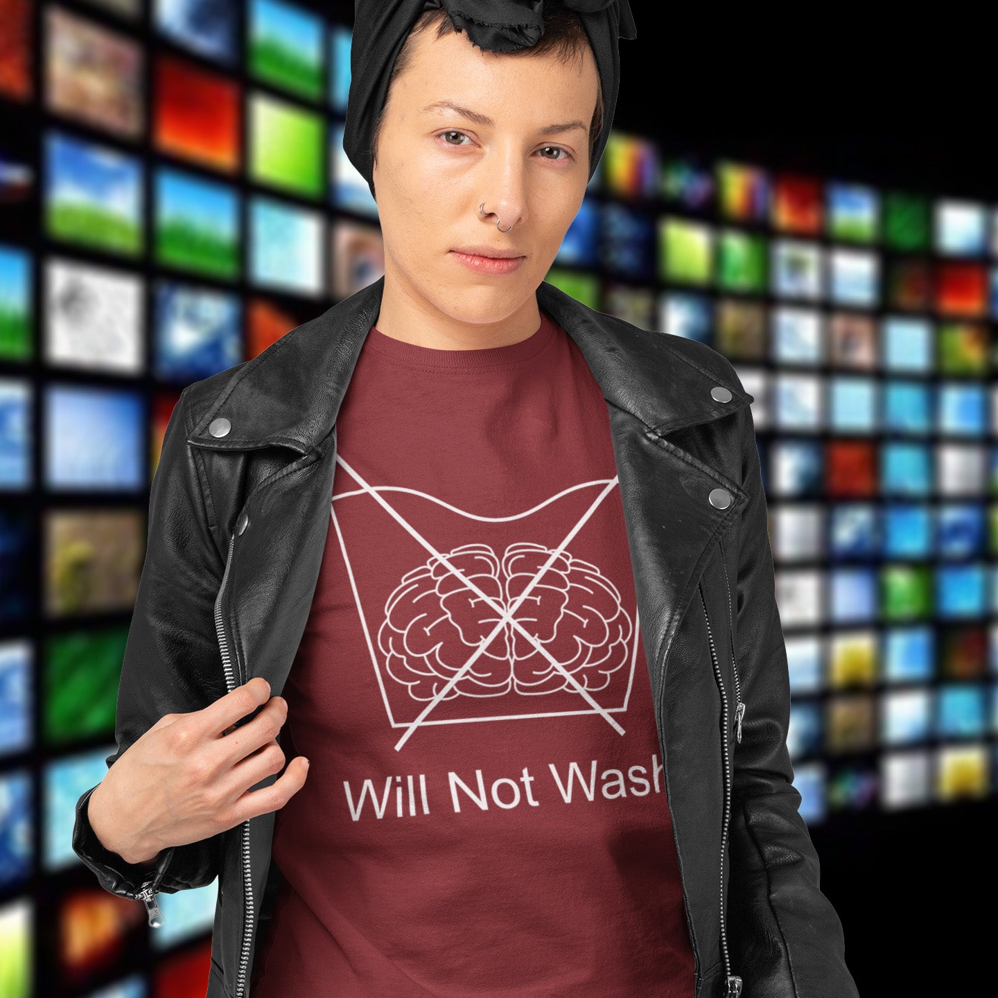 Person wearing a burgundy t-shirt with a brain graphic and text, standing in front of a colourful grid background. A self worth t shirt promoting a strong mind and a resistance to brainwashing. this unique anti-establishment t-shirt design is a play on washing instructions and highlights the mass influence and indoctrination in modern society. Made from 100% organic ring-spun cotton, this clever slogan t shirt is unisex, high-quality, super comfy, and best of all, eco-friendly.