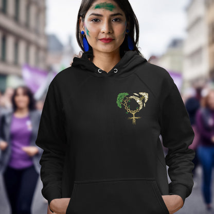 Person wearing a black hoodie with a symbol on it, standing in an urban setting. A women's rights hoodie design that pays homage to women and promotes social awareness of how most destructive elements of humankind come from men. Women create life, men destroy it. Comfortable and practical. It's extra soft and has a convenient front pouch pocket. Made from organic cotton and recycled polyester, this women's rights hoodie is a great eco-friendly choice.